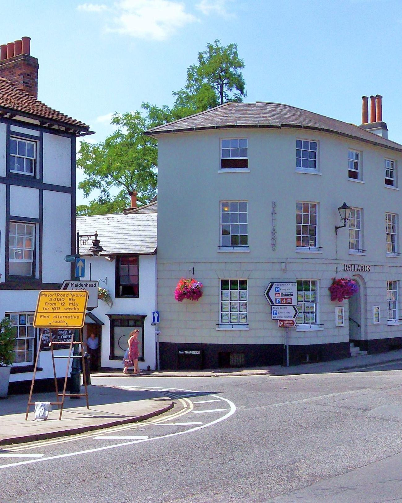 The Angel on the Bridge pub at Henley-on-Thames, with the Thames flowing past and the Grade I-listed Henley Bridge stonework rising behind. Six minutes' walk from 24 Thameside.